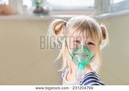 Happy Smiling Kid Using Nebuliser Mask. Inhalation Therapy Curing Chest Cold And Coughing. Healthcar