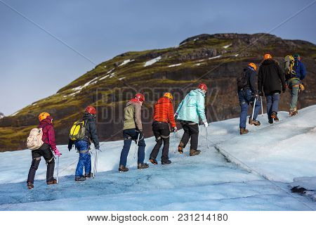 Group Of Hiker Walk On Glacier At Solheimajokull