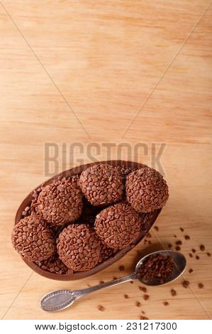 Chocolate Egg With Filling For Easter On Wooden Background