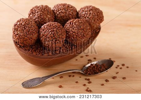 Chocolate Egg With Filling For Easter On Wooden Background
