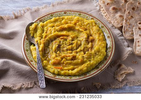 Stewed Yellow Peas With Carrots, Onions And Spices On A Wooden Table With Chapatti, Selective Focus
