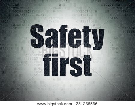 Safety Concept: Painted Black Word Safety First On Digital Data Paper Background