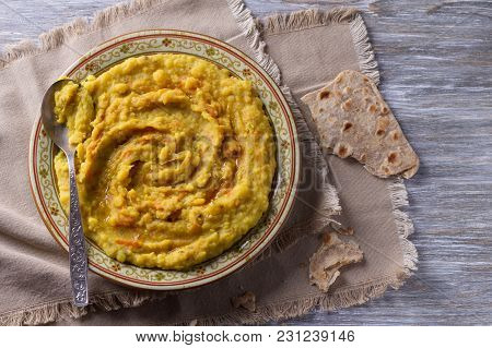 Stewed Yellow Peas With Carrots, Onions And Spices On A Wooden Table With Chapatti, Selective Focus,