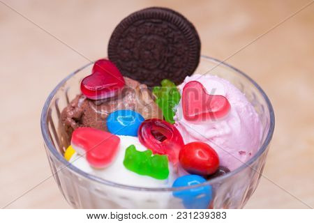 Pink ice cream croissant with biscuits and sweets