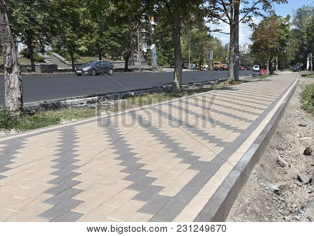 The Pedestrian Walkway Of The City Is Paved With A New Paving Slab. The Final Stage Of Repair Of The