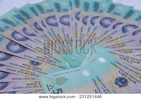Vietnamese Money Dong On White Table. Just Printed Asian Money. Asian Money Fan Out. Concept Of Rich