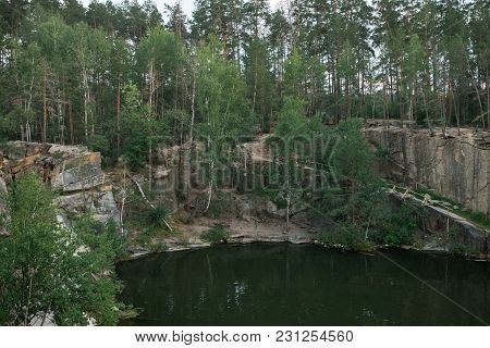 A Lake In A Stone Quarry Surrounded By Trees. Korostyshevsky Canyon. Zhytomyr Region. Ukraine.