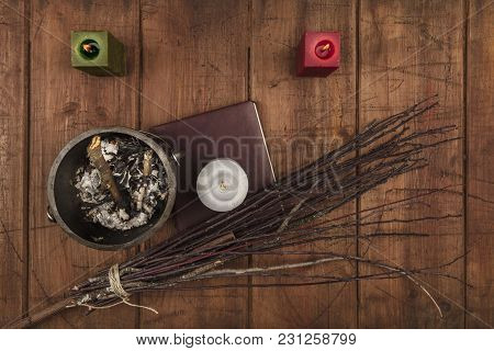 Overhead Photo Of Cauldron, Grimoire, Candles, And A Broom