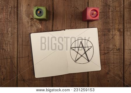 An Overhead Photo Of Two Candles And An Open Grimoire With Copy Space