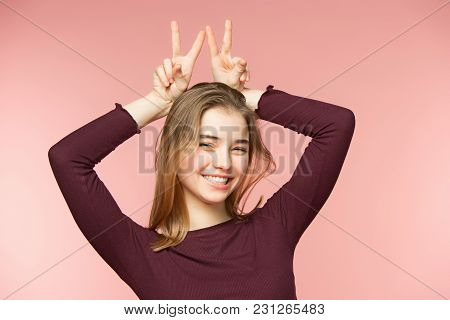 Woman Smiling With Perfect Smile And White Teeth On The Pink Studio Background And Looking At Camera