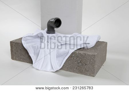 A Metaphor Of Periscope Made With Pipes Emerging From A Y-front Male Underwear On Cinder Block. Mini