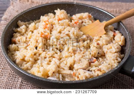 Frozen Pilaf In A Frying Pan. A Dish Of Rice With Meat.