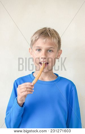 Child Eating Popular Sweat Spanish Dessert Churros.