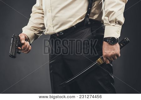 Cropped Shot Of Yakuza Member With Tanto Knife And Gun