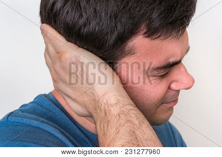 Man With Earache Is Holding His Aching Ear - Body Pain Concept