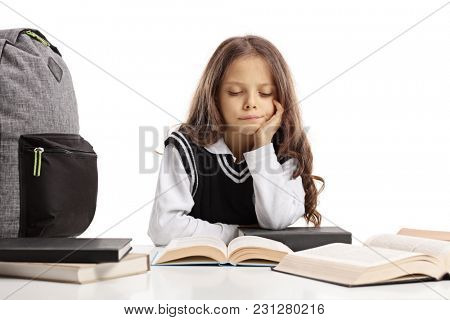 Schoolgirl seated at a table studying unwillingly isolated on white background