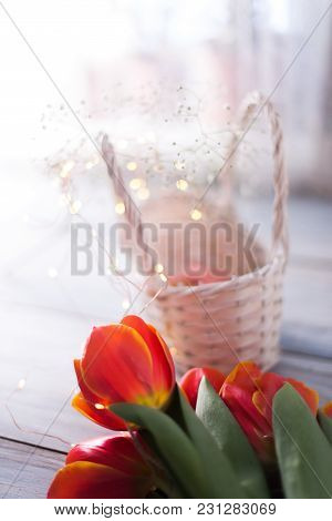Tulips On A Wooden Background With Marshmallows In A Wooden Basket.