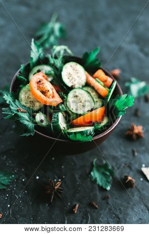 Fresh Salad With Vegetables On A Black Matte Background. The Concept Of A Healthy Diet.