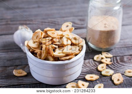 Garlic Chips, Natural Organic Seasoning On Old Wooden Background, Close Up