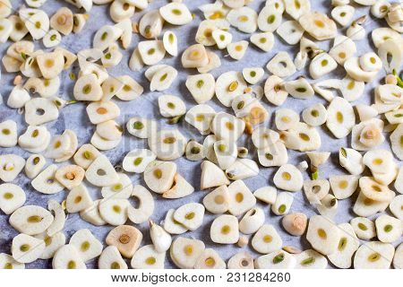 Slices Of Garlic On A Baking Sheet For The Preparation Of Dried Seasoning, Close Up