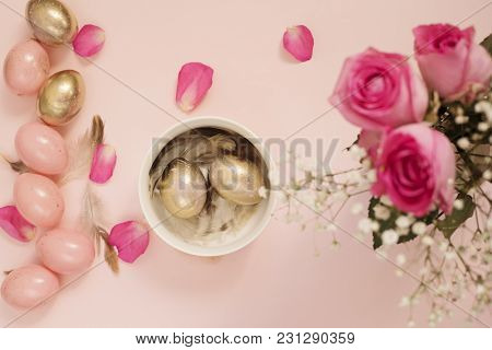 Easter Eggs In A Bowl. Pink And Gold Easter Eggs. Pastel Easter Concept With Eggs, Flowers And Feath