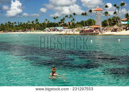 Relaxing Tourist Swimming On The Dominicus Beach On Dominican Republic. Coast Of The Del Este Nation