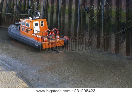 Whitstable, Uk - August 7, 2014: Pluto, A Large Moored Cargo Ship Preparing For The Local Harbour Da