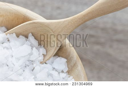 Sea Salt In A Wooden Bowl With Spoon On The Table. Salt Is Used For Seasoning And Making Beauty Trea