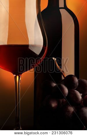 Goblet Of Red Wine With Bottle And Bunch Of Grap