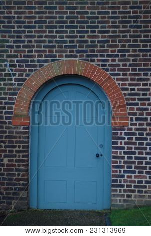 Blue Vintage Round Door In Brick Wall, London, Valentine's Park. Decorative Old Door.