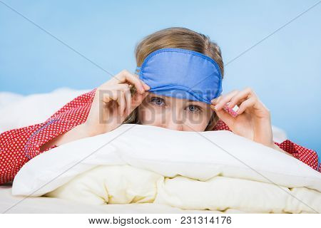 Sleepy Young Woman Wearing Sleeping Eye Band Lying In Bed Before Going To Sleep.