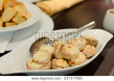 Blurred Photo With Shallow Depth Of Focus Taken With Diafragma 1.8  - Dish Of Baked Mushrooms Champi