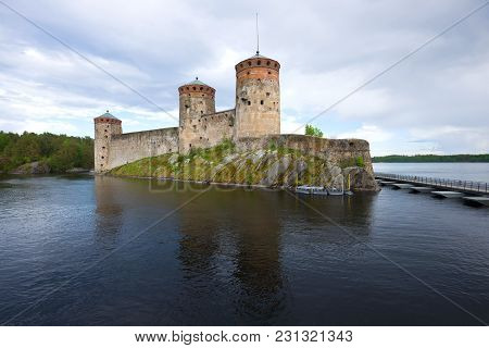 View Of The Olavinlinna Fortress On A Cloudy June Evening. Savonlinna, Finland