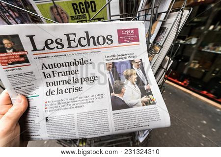 Paris, France - Mar 15, 2017: Man Reading Buying French Les Echos Newspaper At Press Kiosk Featuring