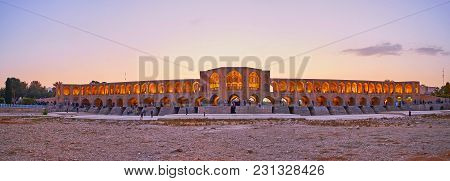 Isfahan, Iran - October 20, 2017: The  Evening Panorama Of Khaju Bridge From The Dried Up Bottom Of 