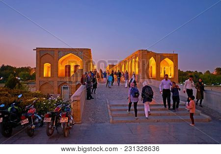 Isfahan, Iran - October 20, 2017: The Evening Walk Along The Crowded Khaju Bridge - One Of The Centr