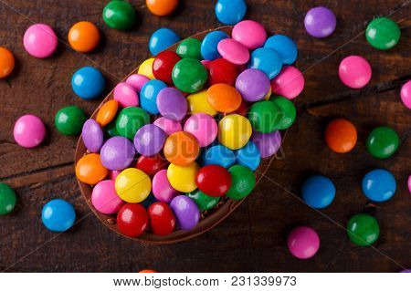 Chocolate Egg With Filling For Easter On Wooden Background