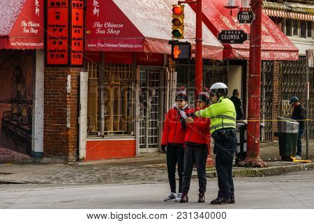 Vancouver, Canada - February 18, 2018: Vancouver Police Officers Talking To People In Vancouver Chin