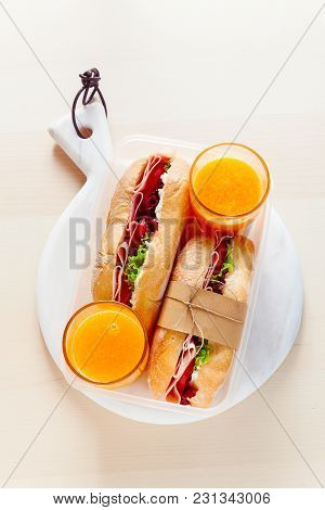 Light Healthy Snack In The Form Of Italian Sandwiches In A Lunch Box On A Marble Cutting Board And F