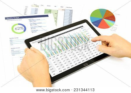 Composite Image Of Businessman Analyzing Investment Charts On The Digital Tablet At The Office.