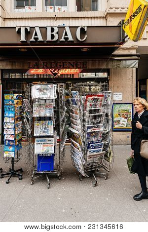 Paris, France - Mar 15, 2018: Senior Man Buying French Newspaper Liberation At Parisian Press Kiosk 