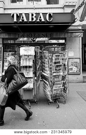 Paris, France - Mar 15, 2018: Senior Man Buying French Newspaper Liberation At Parisian Press Kiosk 
