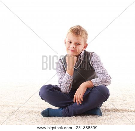 Beautiful Teenager Looking At Camera And Smiling While Sitting On The Floor On A White Background
