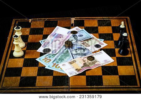 Chess Board With Cash And Chess On A Dark Background