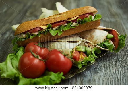 Shaurma Chicken Roll In A Pita With Fresh Vegetables And Long Subway Sandwich With Tomatoes, Cucumbe