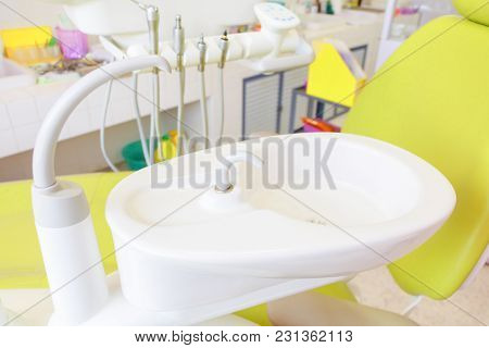 Sink Medical Equipment Dentist Close Up, Ceramic Spittoon And Water Filler In Clinic