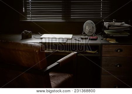 Work space on black table of a photographer or designer with laptop , retro camera and fan , Stylish