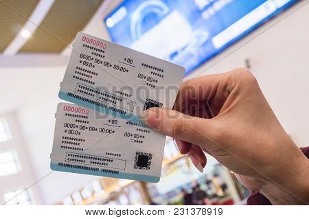 Two Tickets For A Modern High-speed Train Crh In The Hands Of A Woman At The Train Station. Data Of 