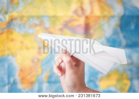 Paper Airplane In Hand On World Map Background . Travel Concept