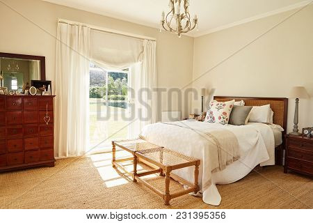 Interior Of The Bright Master Bedroom Of A Contemporary Residential Home With A Comfortable Bed And 